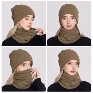 Detail view of olive green knitted beanie and neck warmer set with fine ribbed texture
