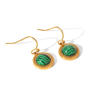 Close-up of golden drop earrings featuring green malachite stones and beaded edges