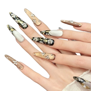 Luxurious black and gold floral stiletto press-on nails with 3D butterfly and cat eye effect