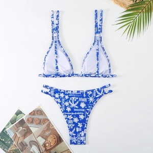 Close-up of tropical floral blue bikini with double straps and side cutout details