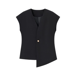 Detail of black sleeveless vest featuring V-neckline and asymmetrical hem with metal button