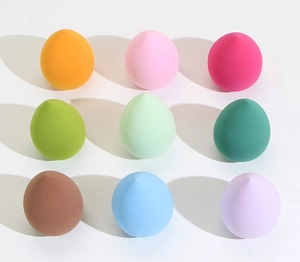 Detailed grid display of nine colorful non-latex makeup sponges in teardrop shape