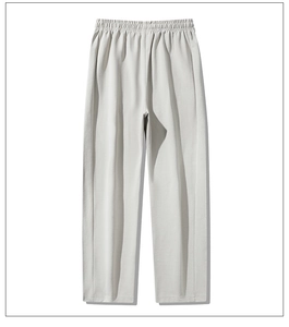 Detail of light grey casual straight-leg sweatpants showing elastic waistband and fabric texture
