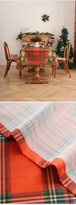 Close-up of red and green plaid Christmas tablecloth showing woven texture and festive patterns