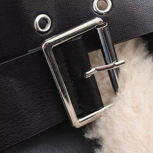 Women's autumn jacket with black faux leather strap, silver buckle, and beige fur lining