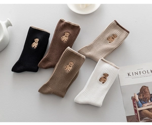Detailed view of five cotton crew socks in neutral tones with bear embroidery
