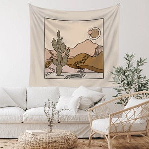 Minimalist bohemian desert wall tapestry showing cactus and mountains in a warm room