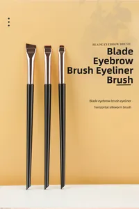 Detailed view of three angled eye makeup brushes with slim black handles and silver ferrules