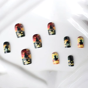 Halloween press-on nails featuring black cats and orange pumpkin designs on short square tips