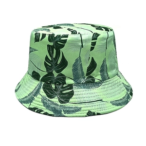 Detailed view of the tropical palm leaf pattern and reinforced stitching on a green sun hat