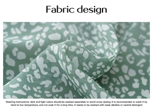 Detailed view of green floral fabric texture with washing instructions for long sleeve shirt