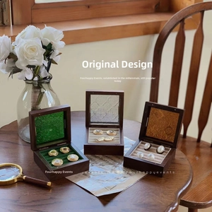 Macro detail of walnut wood jewelry boxes with vintage embossed patterns and velvet lining
