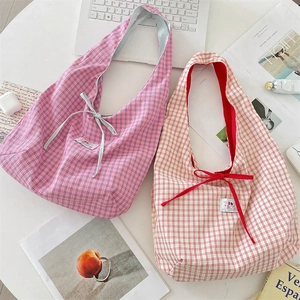 Top view of large plaid tote bags with bow details in pink and red color options