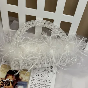 Close-up of white ostrich feather handbag with transparent crystal beaded craftsmanship