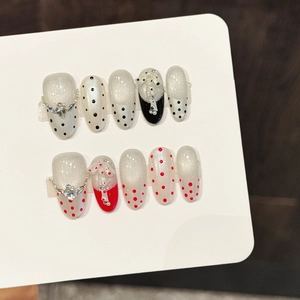 Handmade press-on nails with red and black polka dots, 3D bows and pearl accents