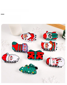 Detailed flat lay of colorful Christmas themed hair claw clips with resin festive patterns