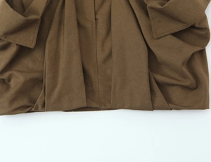 Close-up of dark brown cotton cargo skirt showing precision stitching and fabric texture