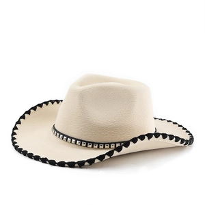 Close-up of beige fedora hat with silver metal studs and black braided edge detail