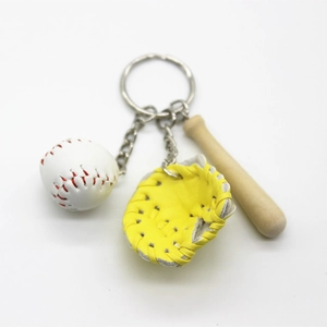 Detailed close-up of a mini baseball keychain set with glove and wooden bat