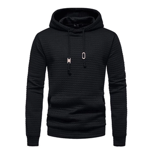Detail of men's black hoodie featuring a unique quilted waffle texture and drawstring hood