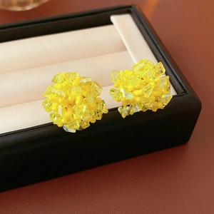 Macro shot of yellow seed bead flower cluster earrings inside a premium black jewelry box