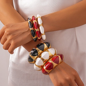 Brushed gold open bangles with geometric enamel inlay in black, white, and red set