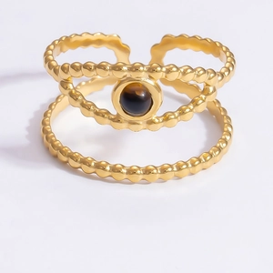 Detail of a gold double-layer open ring with an eye-shaped dark gemstone inlay