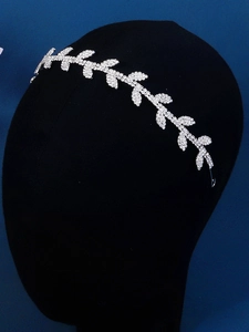 Detailed view of silver leaf headband with shimmering rhinestones on a mannequin