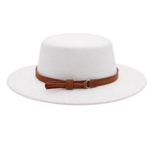 Detail of white wool boater hat with caramel band and gold buckle on plain background