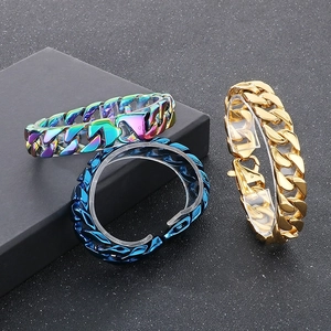Three Cuban link bracelets in rainbow, blue and gold finishes on a black display stand