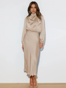 Detailed view of champagne satin halter dress showing elegant silky fabric and waist detail