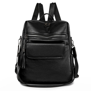 Trendy black leather travel backpack for women with tassels, fits 14-inch laptops