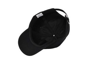 Detail of 100% cotton baseball cap interior with white wash label and metal buckle