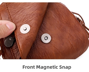 Close-up of magnetic suction clasp and lychee texture on retro brown leather bag