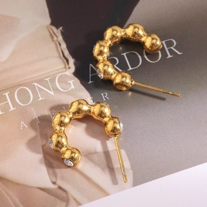 Macro shot of 18K gold plated bubble stud earrings with sparkling clear zircon stones