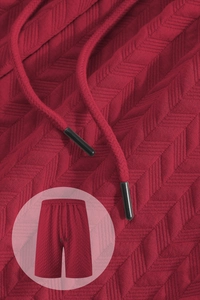 Macro texture of red jacquard fabric with metallic tip drawstring on casual shorts