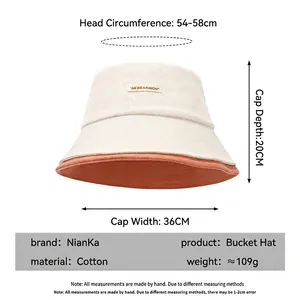 Cappello a secchiello in cotone bicolore beige e arancione con guida alle taglie