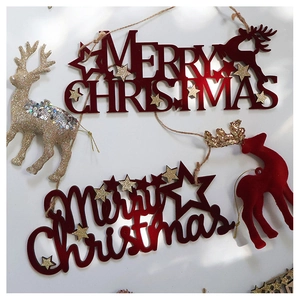 Close-up of red flocked reindeer and golden Merry Christmas glitter tree ornaments