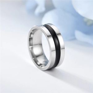 Close-up of polished silver titanium steel ring with black enamel inlay detail