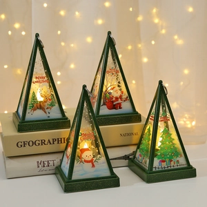 Detail of vintage green Christmas lanterns with Santa and snowman patterns in warm light