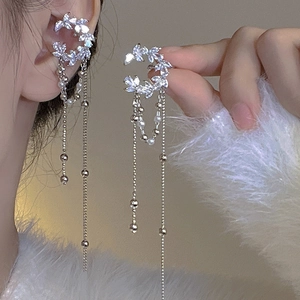 Detail of silver long tassel ear bone clip featuring marquise crystals and tiny pearls