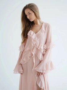 Detail of light pink chiffon dress showing layered ruffles and elegant trumpet sleeves