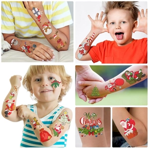 Close-up of waterproof Christmas cartoon temporary tattoos for kids on skin surface