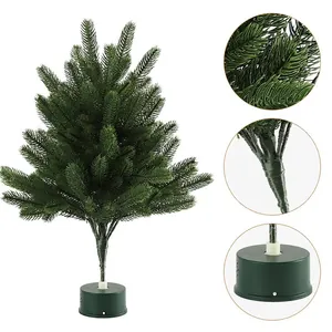 Miniature artificial Christmas tree with dense green needles and round rotating base