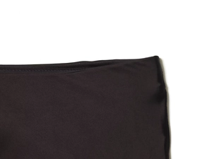 Close-up of the elastic waistband on a smooth black satin midi skirt with lace trim detail