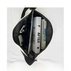 Top view of white canvas messenger bag interior showing spacious storage for laptop and books
