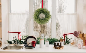 Close-up of Norfolk pine garland with red ribbon and soft PE needles for Christmas decor