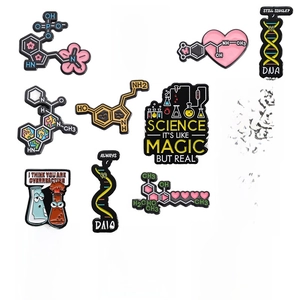 Detailed set of science enamel pins featuring chemical formulas and lab equipment