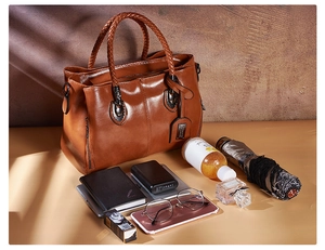 Detail showing the large storage capacity and organized interior of the brown Boston bag