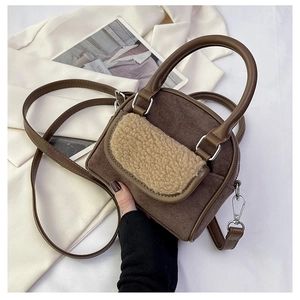 Detail of plush lamb wool patchwork and brown suede material on elegant handbag